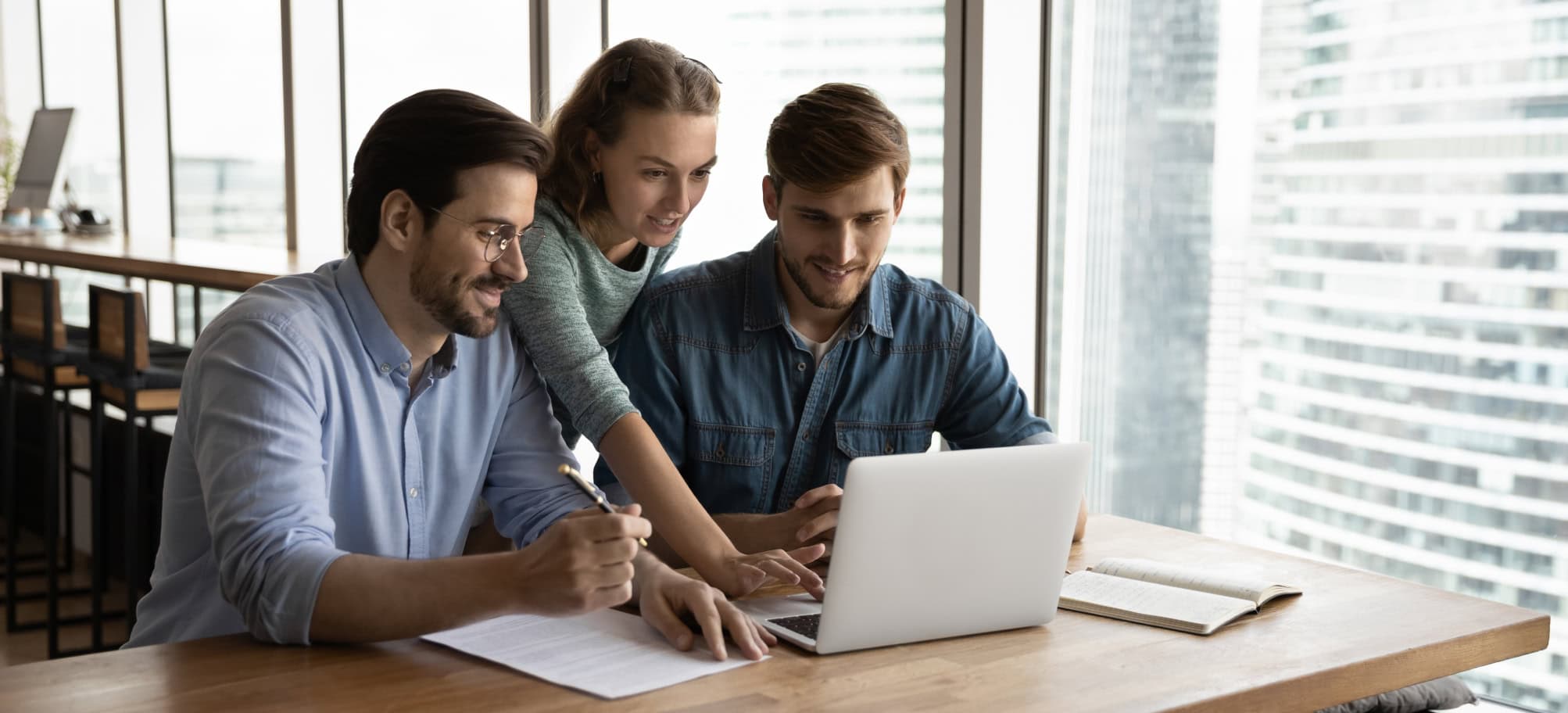 Group of students looking at resources on laptop