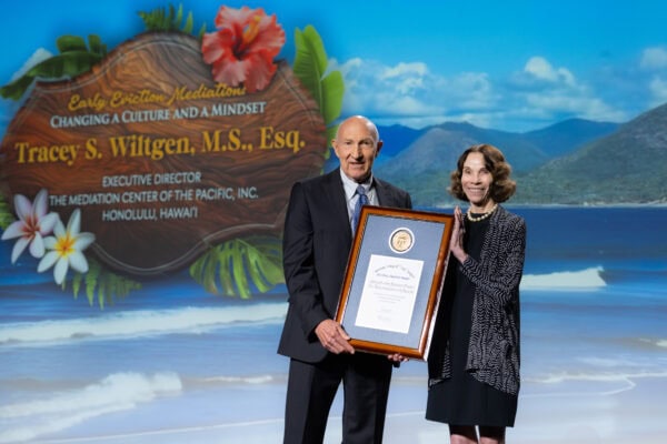 woman and man holding plaque