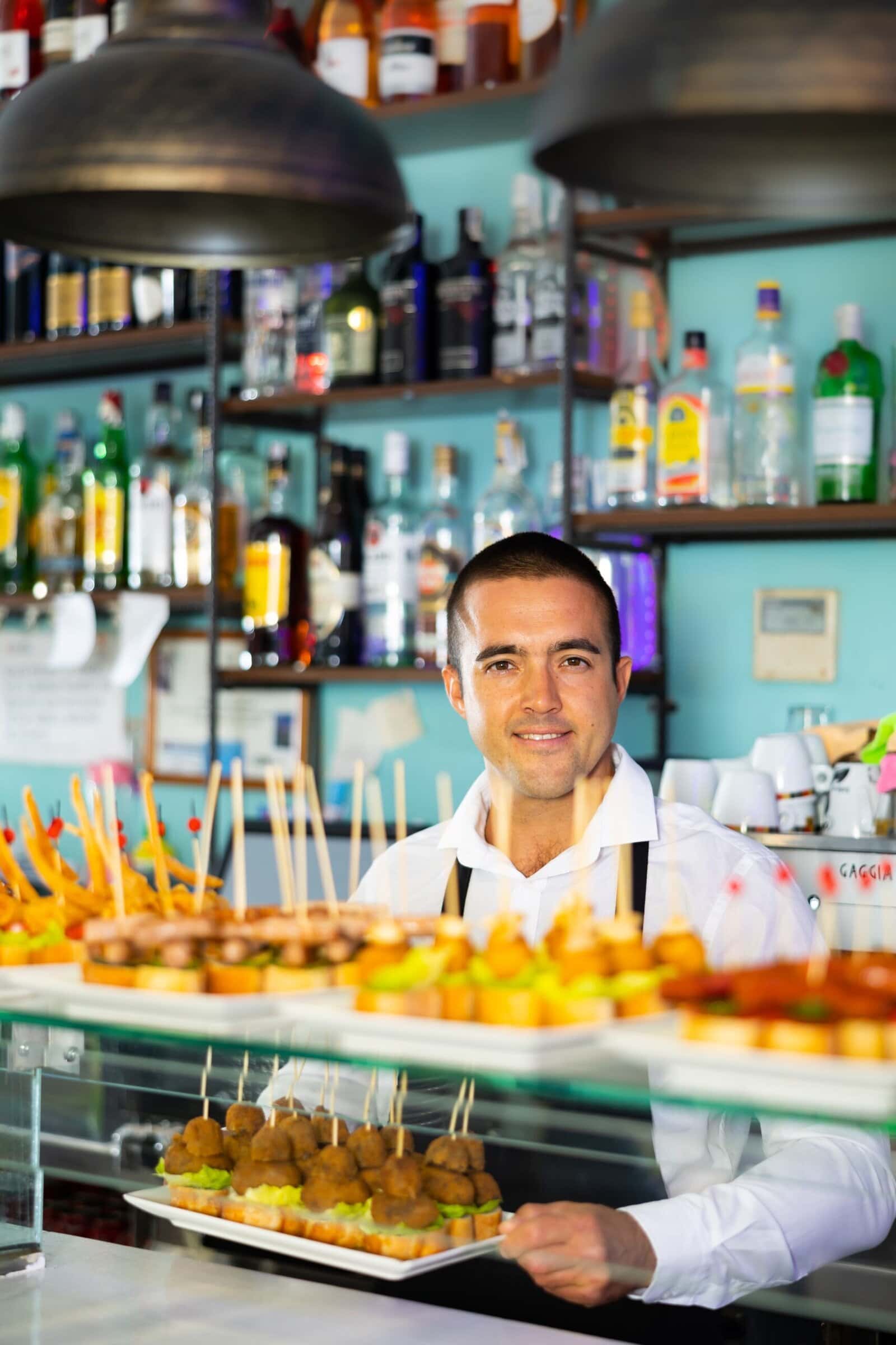Friendly,Young,Male,Bartender,Offering,Appetizing,Pinchos,In,Comfortable,Pub Friendly,Young,Male,Bartender,Offering,Appetizing,Pinchos,In,Comfortable,Pub
